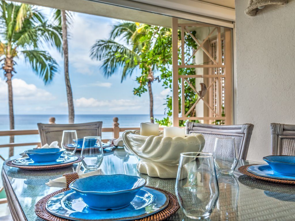 Blue bowls and plates on dining table by the sea